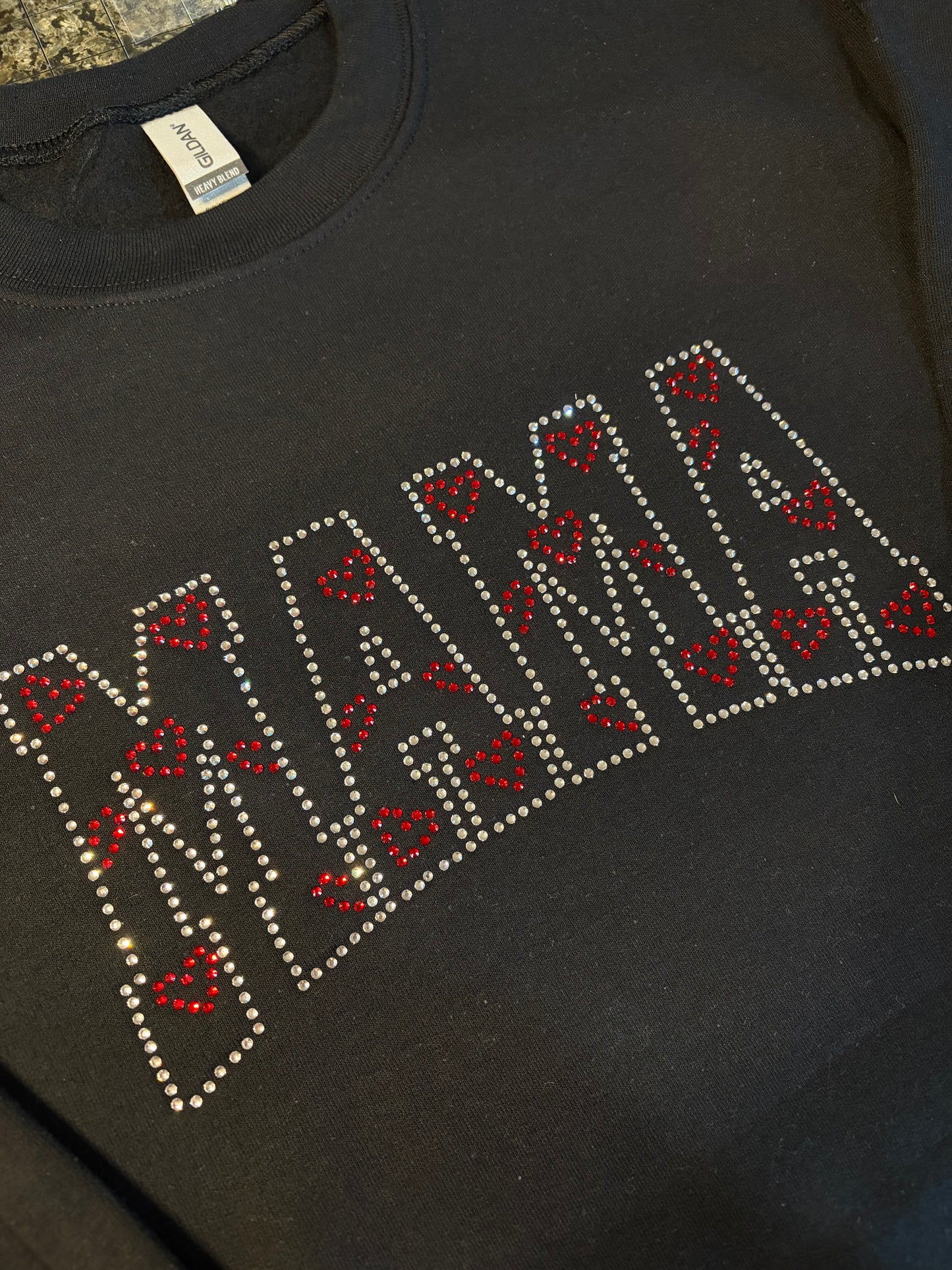 Black sweatshirt with 'MAMA' rhinetones text, closer look